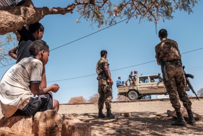 Image: Ethiopian Army soldiers stand as a pick-up truck with militia men passes by at Mai Aini Refugee camp, in Ethiopia, on January 30, 2021. Photo by EDUARDO SOTERAS/AFP via Getty Images