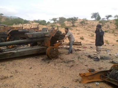 TDF with a damaged D-30 howitzer amidst the remains of a convoy
